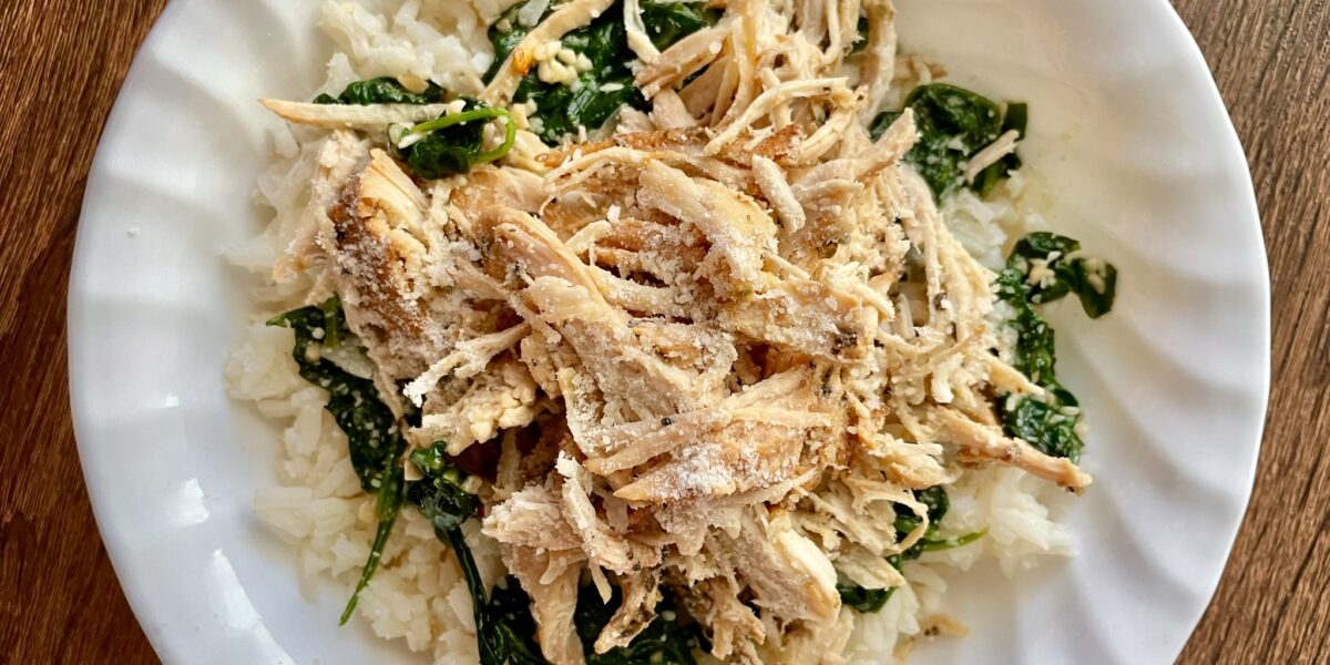 slow cooker italian chicken on a plate over a bed of rice