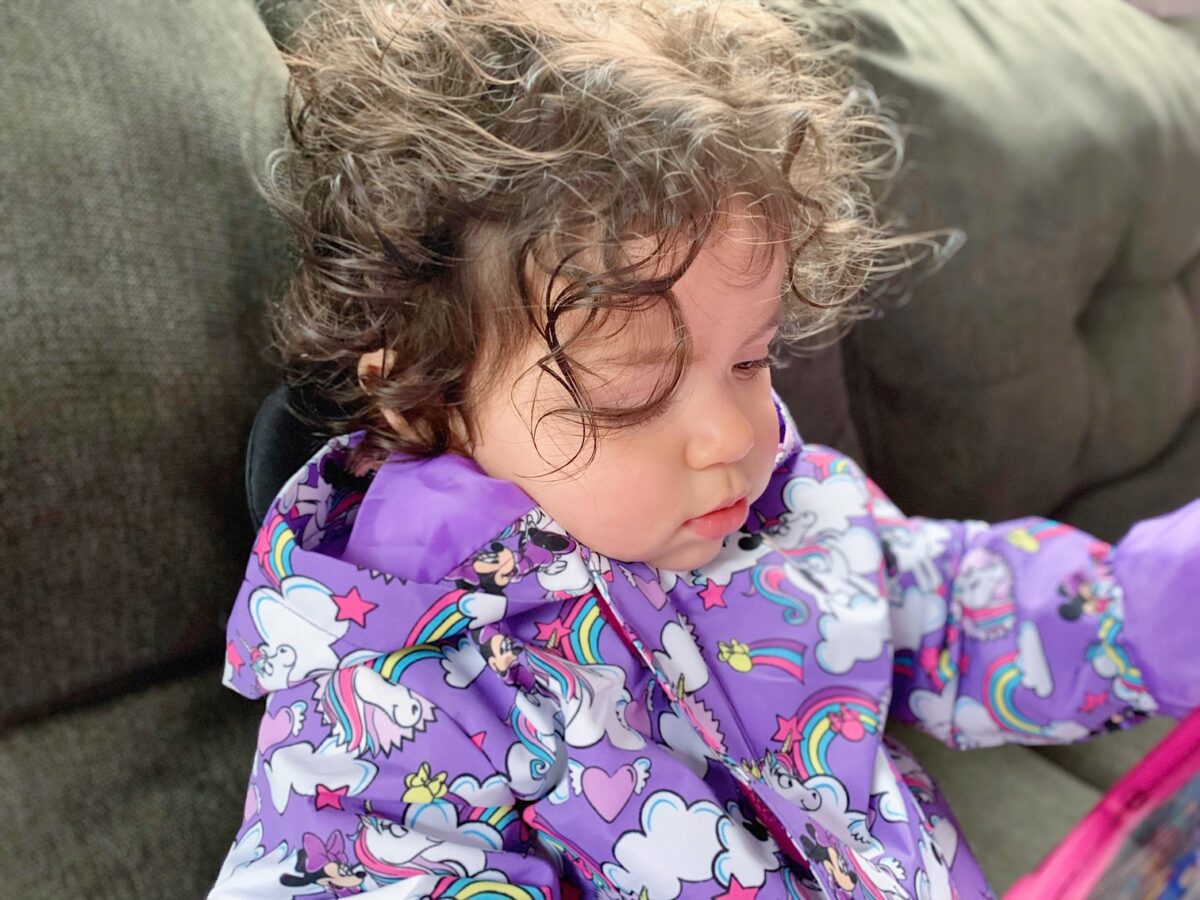 A Curly Hair Kid Sitting on Sofa