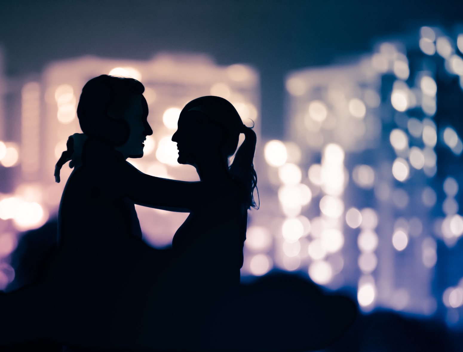 shadow of a couple on a romantic date night with cityscape behind them