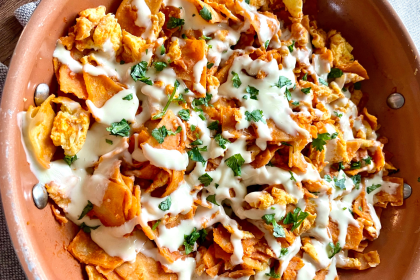 Easy chilaquiles with red sauce, fried tortilla chips, cheese and eggs