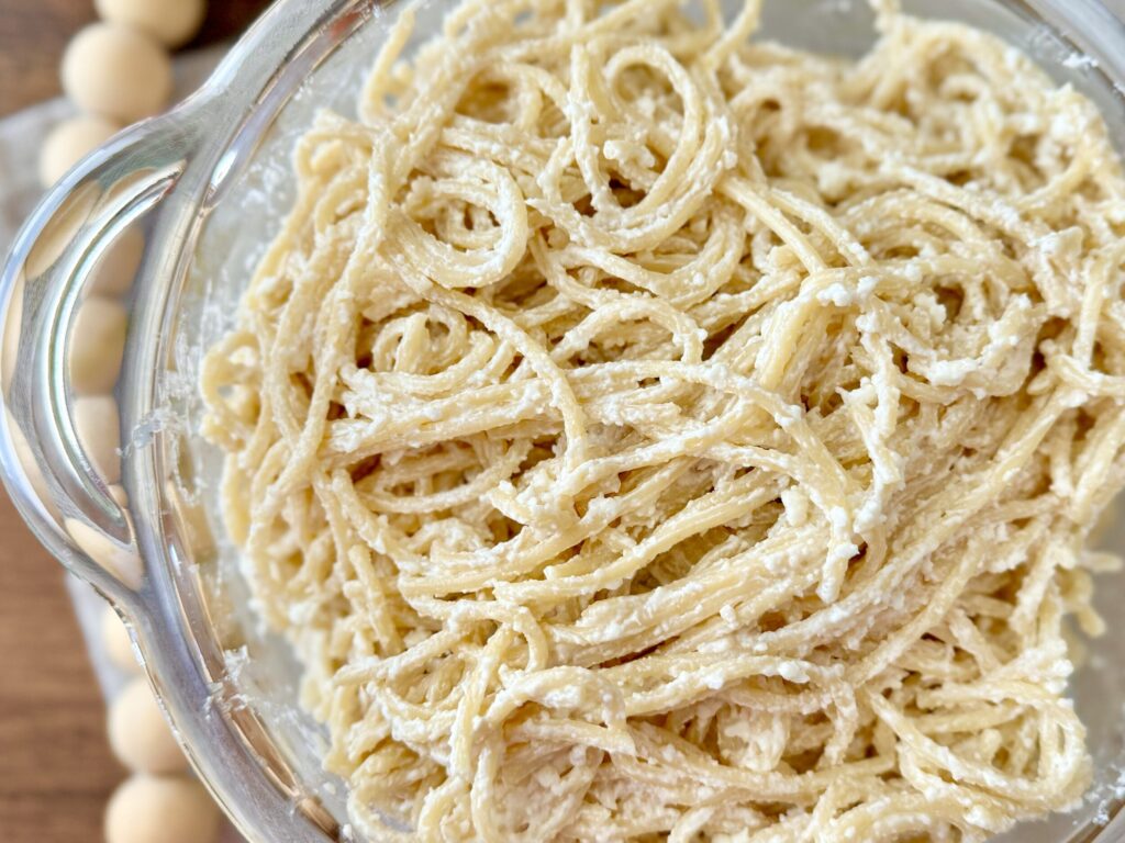 white spaghetti in a clear bowl on a table