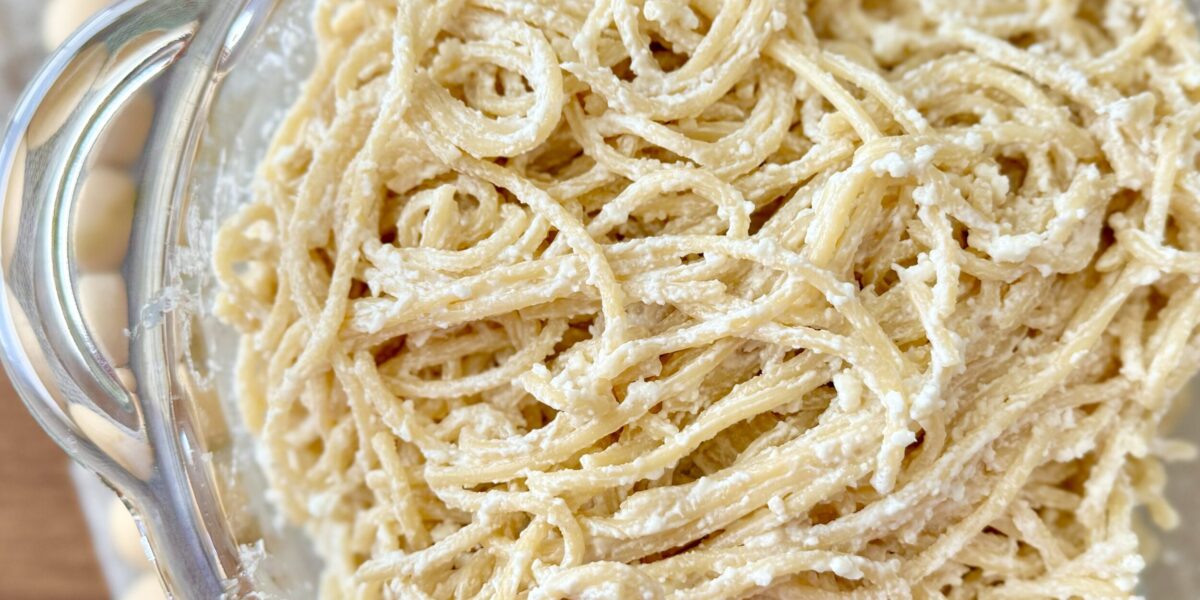 white spaghetti in a clear bowl on a table