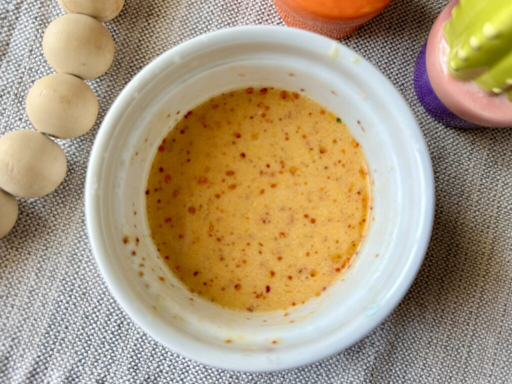 a white bowl with creamy lime dressing 