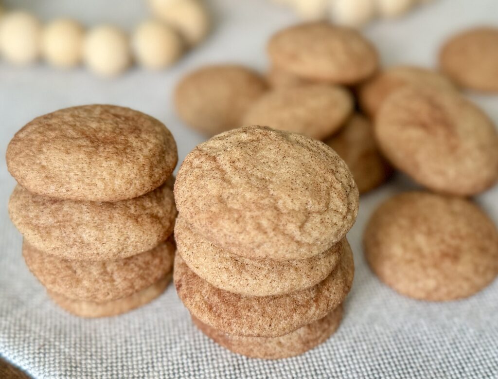 Two short stacks of churro cookies on a table. Easy Churro Cookies Recipe