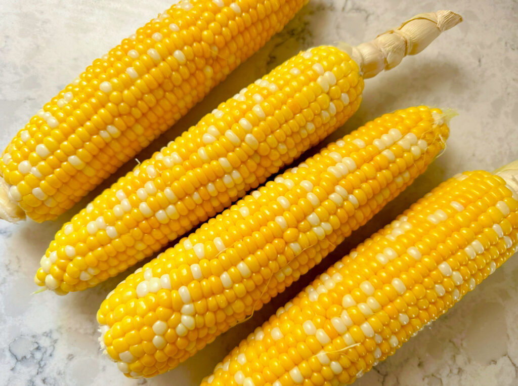 four cooked ears of corn