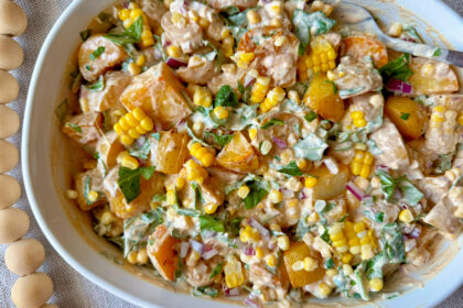 Chipotle potato salad in a large white bowl with colorful ingredients