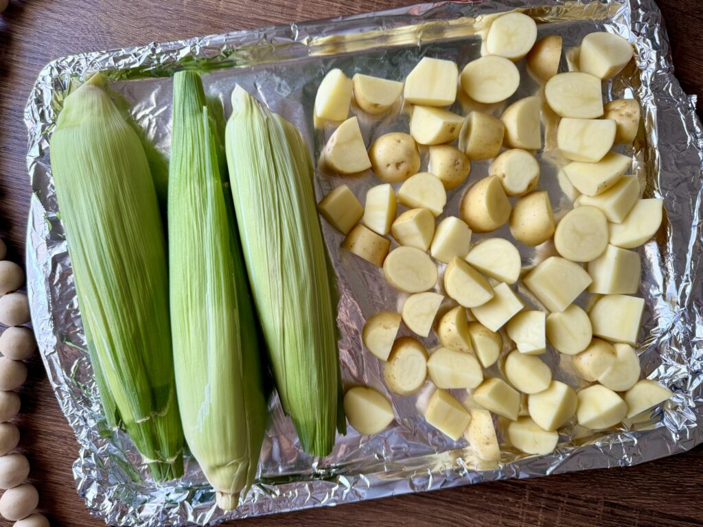 baking sheet with corn and baby potatoes