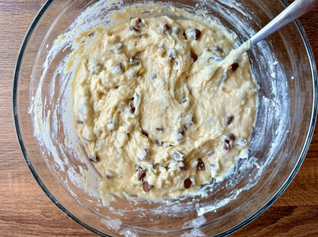 large glass bowl with muffin batter mix in it