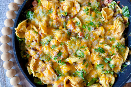 large skillet of southwest tortellini covered in cheese