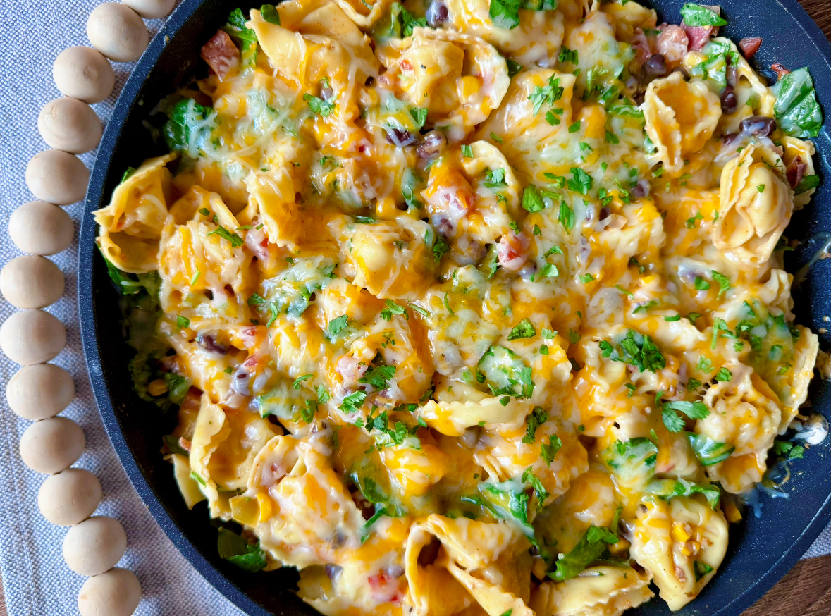 large skillet of southwest tortellini covered in cheese