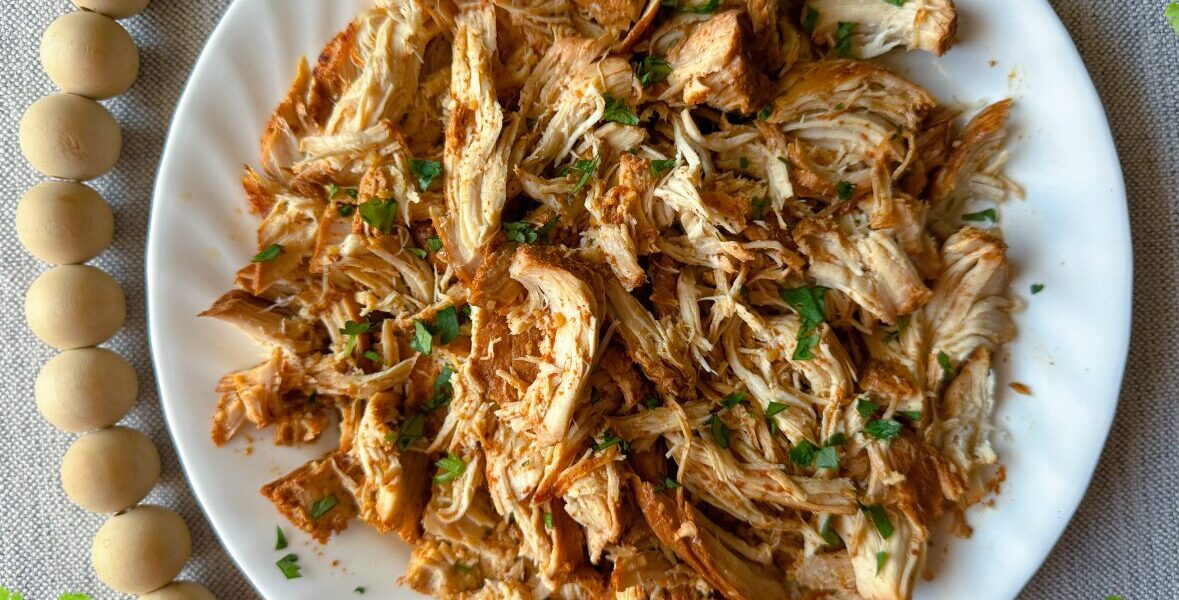 white plate of honey chipotle chicken with cilantro accents