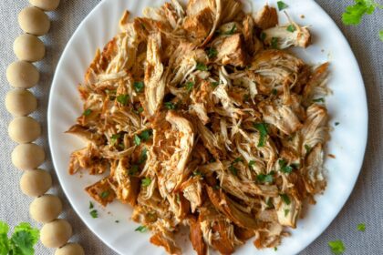 white plate of honey chipotle chicken with cilantro accents