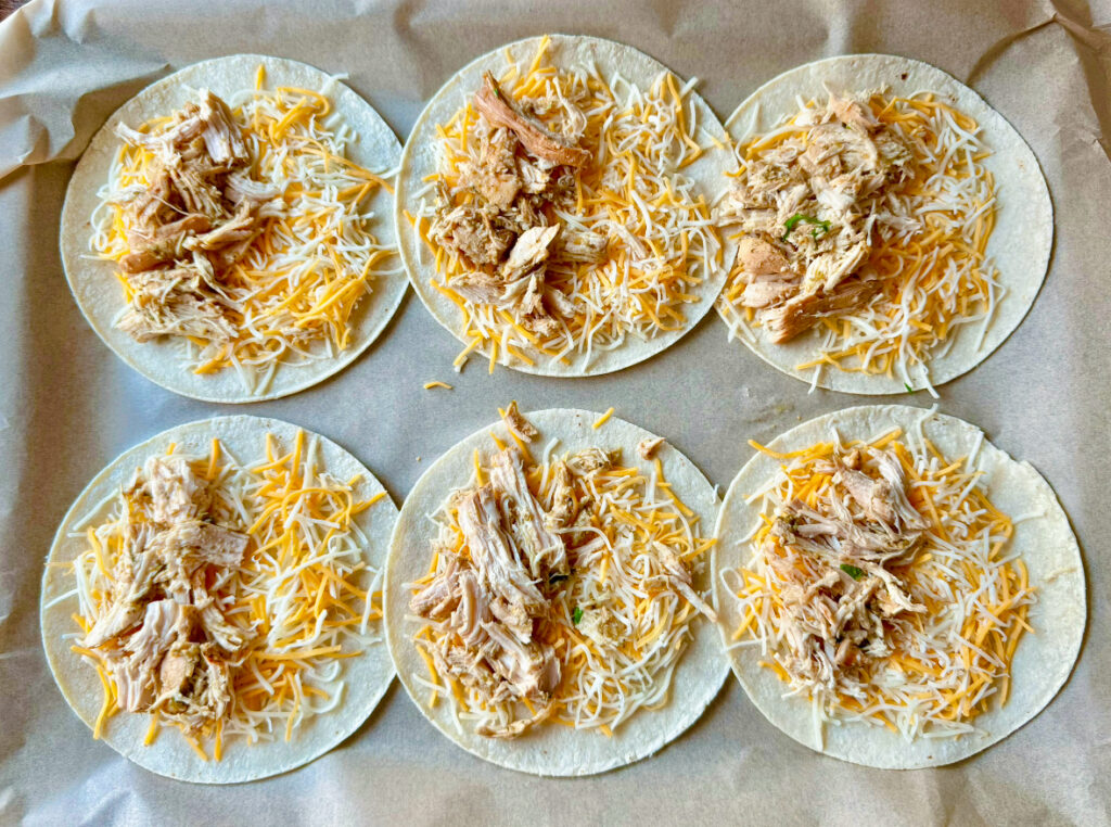 six open faced tacos with chicken and cheese