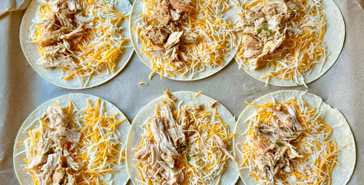 six open faced tacos with chicken and cheese