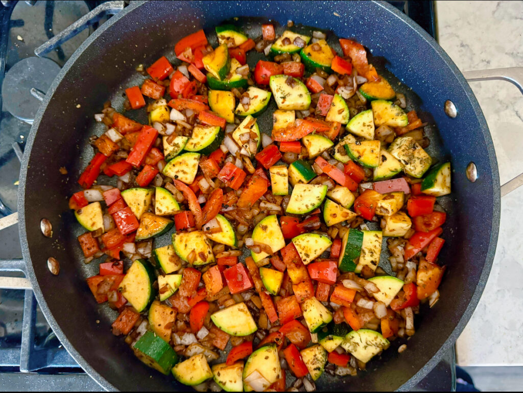 skillet with veggies used in Mediterranean Chicken Orzo skillet 