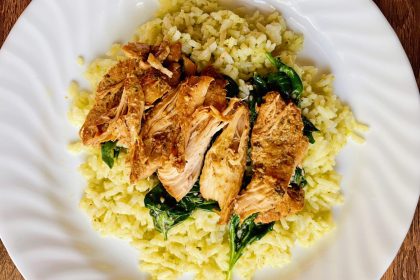Easy Slow Cooker Italian Chicken Breast on a white plate with rice and spinach
