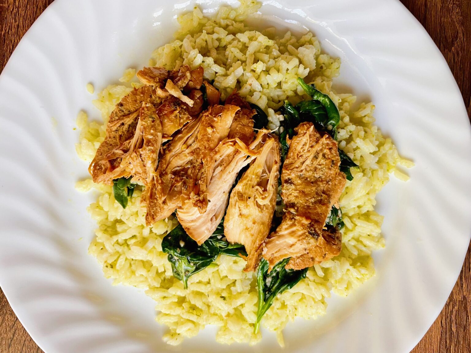 Easy Slow Cooker Italian Chicken Breast on a white plate with rice and spinach
