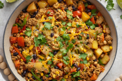 Overhead shot of a one pot ground turkey and potato skillet with black beans, corn, bell peppers, and melted cheese.