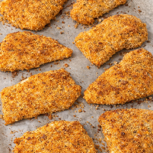 crispy oven fried chicken pieces on a baking sheet