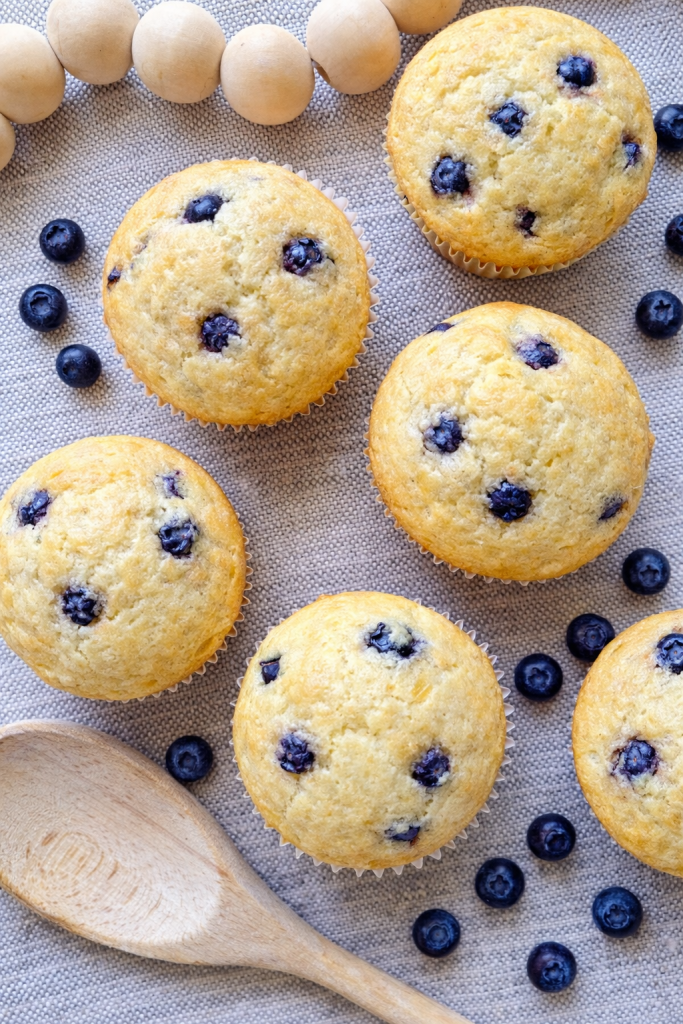 Lemon blueberry Greek yogurt muffins baked until golden with fresh blueberries throughout.