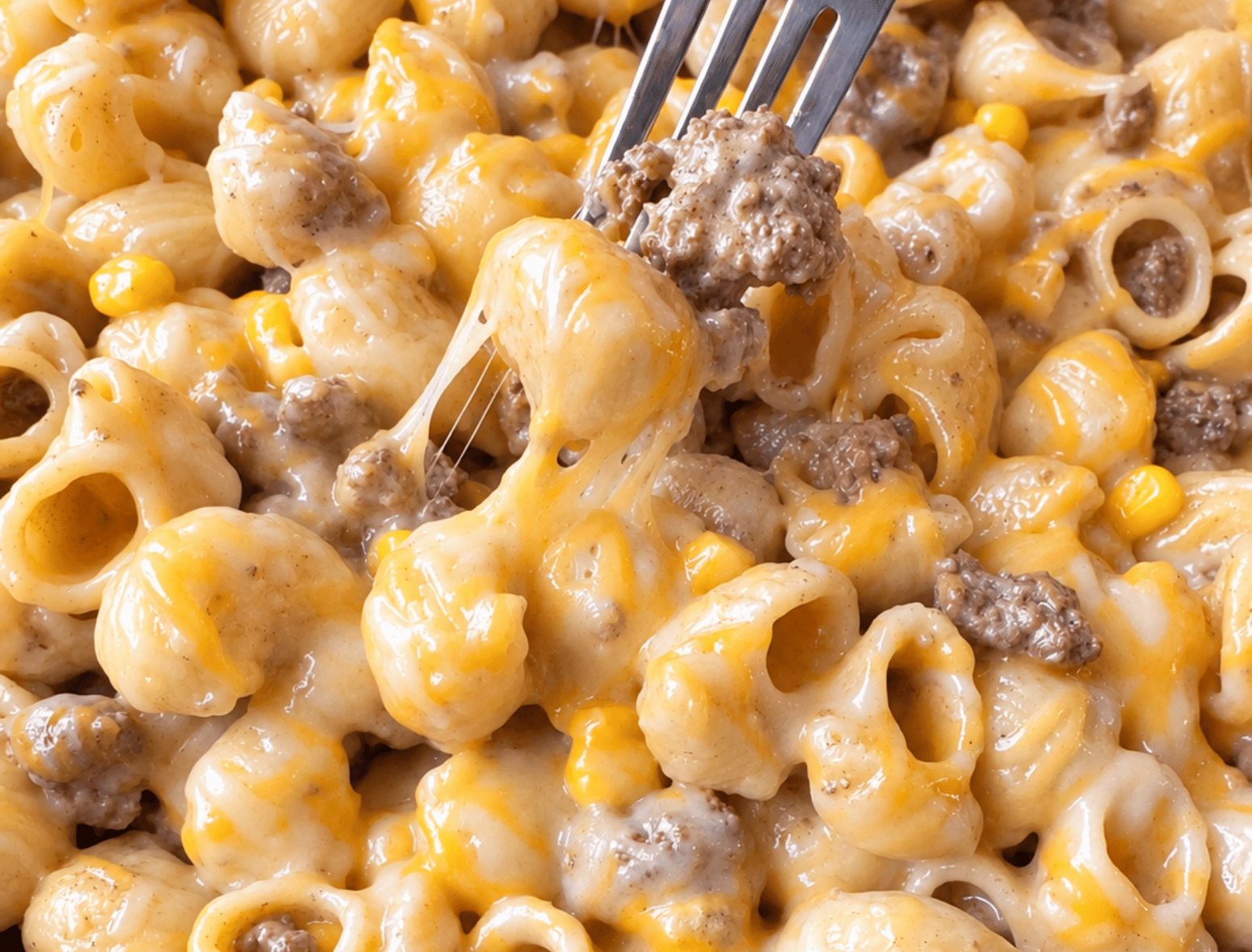 close up shot of a forkful of cheesy, creamy chipotle lime beef pasta