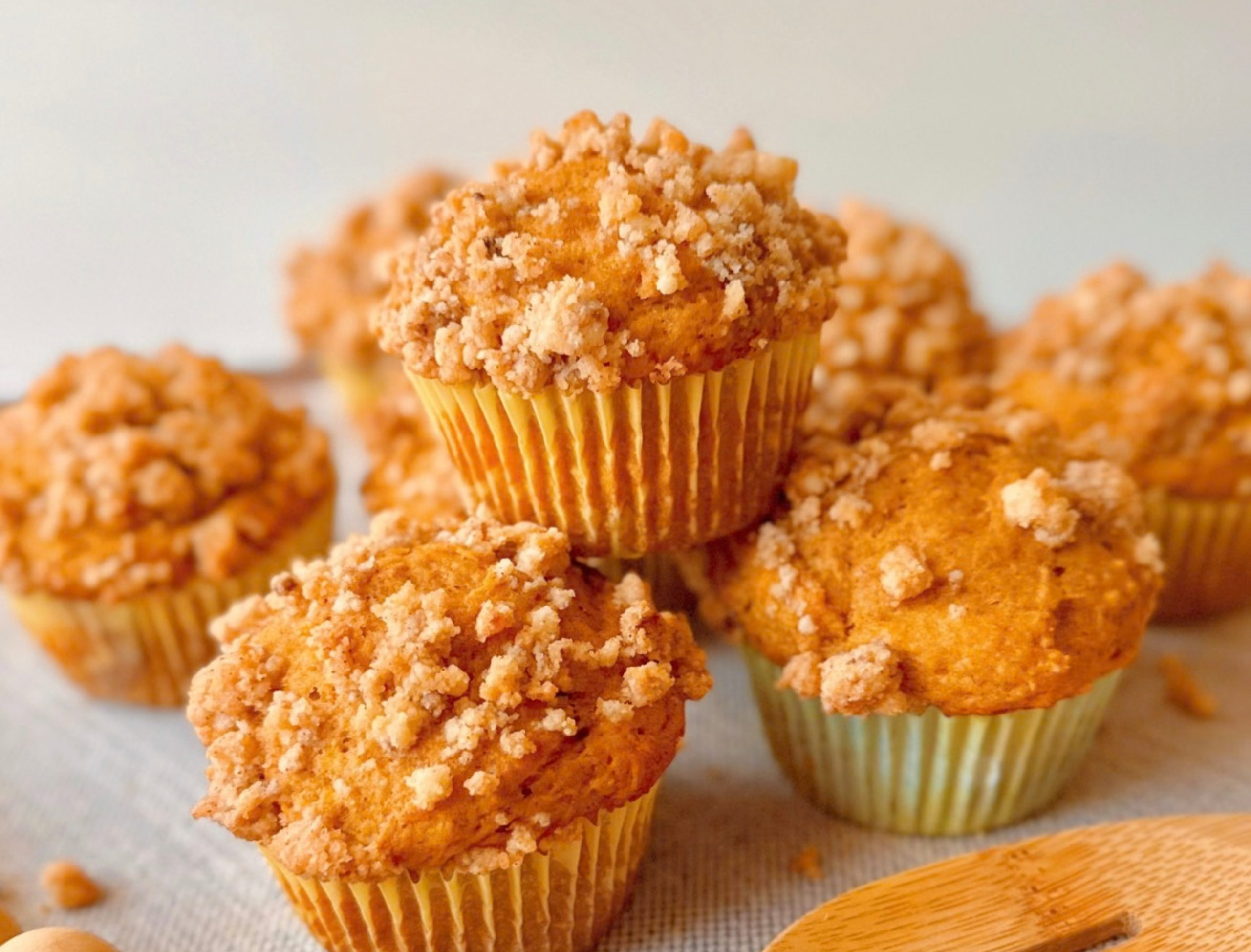 close up of a greek yogurt pumpkin muffin with cinnamon brown sugar streusel topping