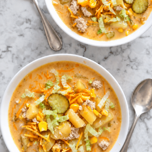 two white bowls with individual servings of turkey cheeseburger soup